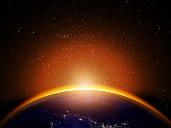 Sunrise seen from space casts a glow along the curve of the Earth