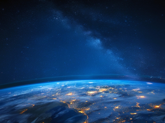 Earth seen from space at night with city lights glowing