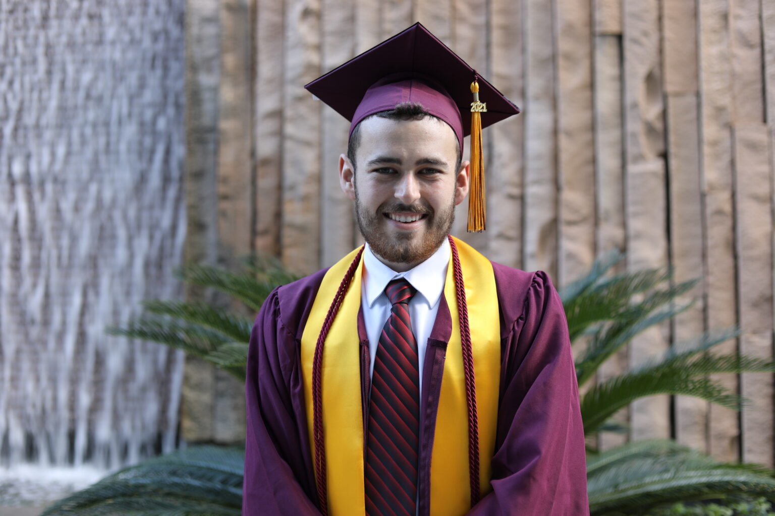 Parker Cohensill wearing ASU cap and gown for graduation