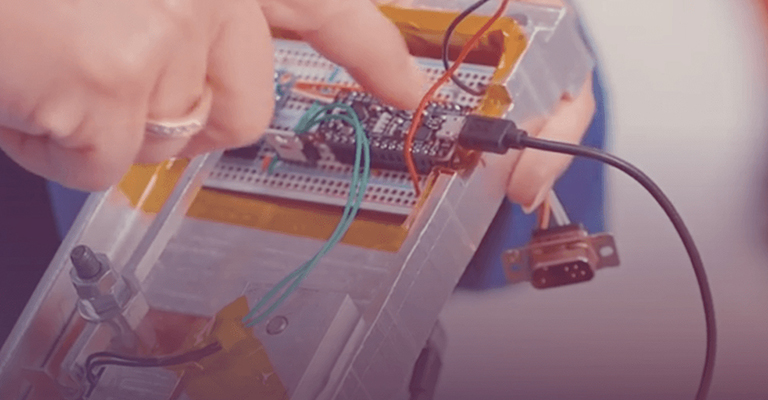 Hands working on a circuit board