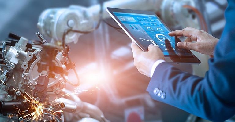 A man controls a robotic arm using a tablet
