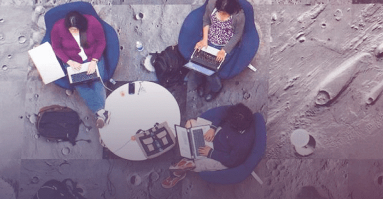 Students, shown from above, work at computers in a lounge carpeted to look like the surface of the moon in ASU's ISTB4 building